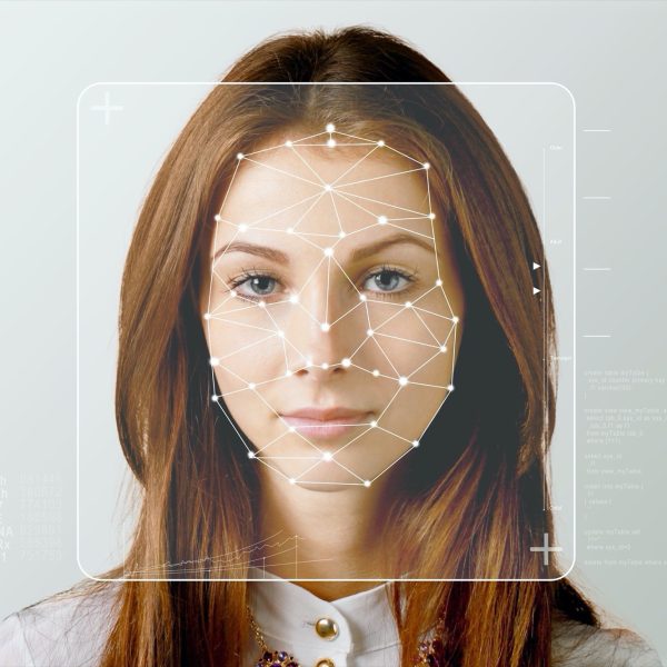 Serious business woman and smart technology for face recognition, double exposure.